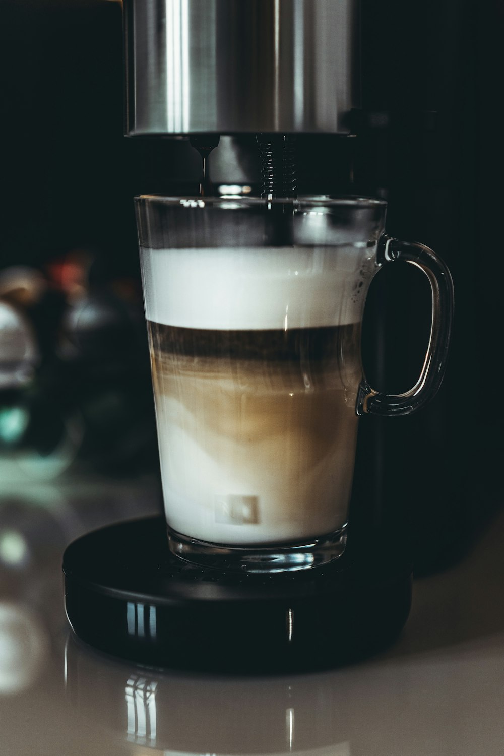 a cup of coffee sitting on top of a table