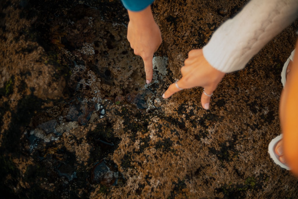 a close up of a person pointing at something