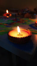 Devotees lighting diyas in front of a glowing Hanuman idol during evening aarti.