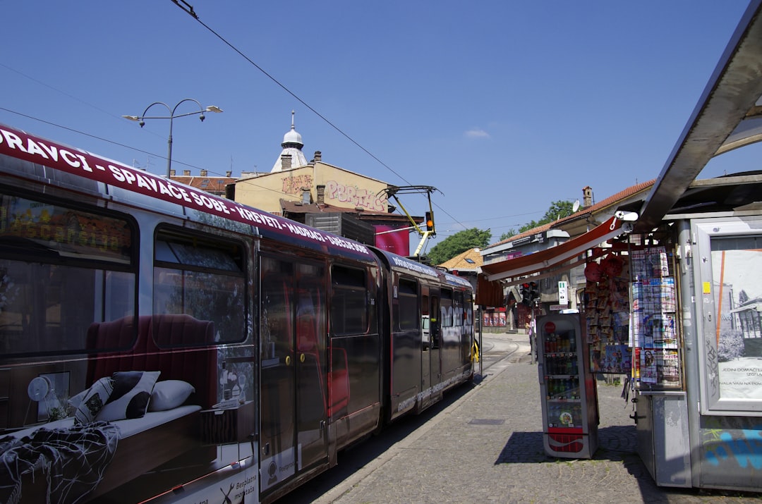 a train parked next to a building on a street,