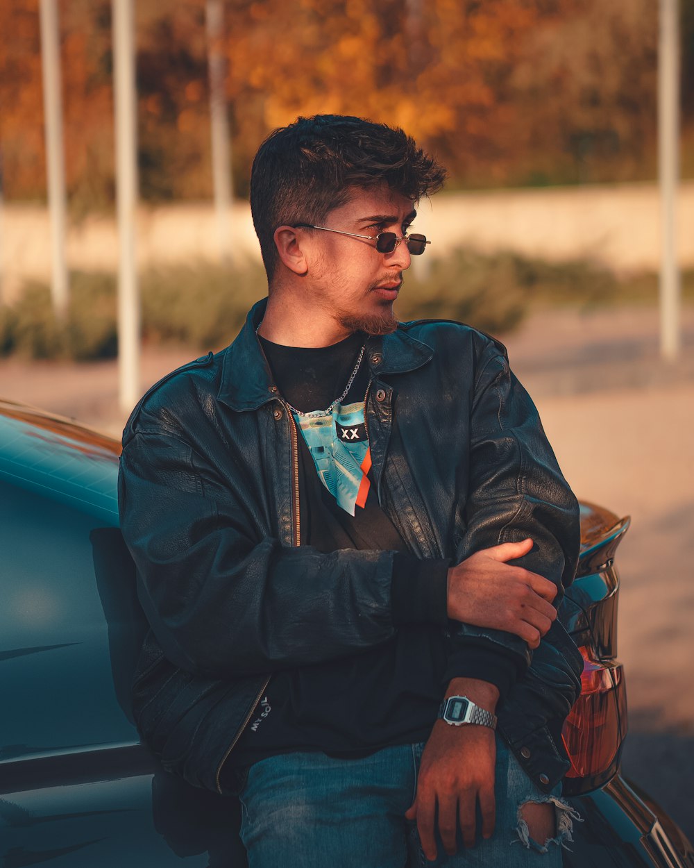 a man sitting on the hood of a car