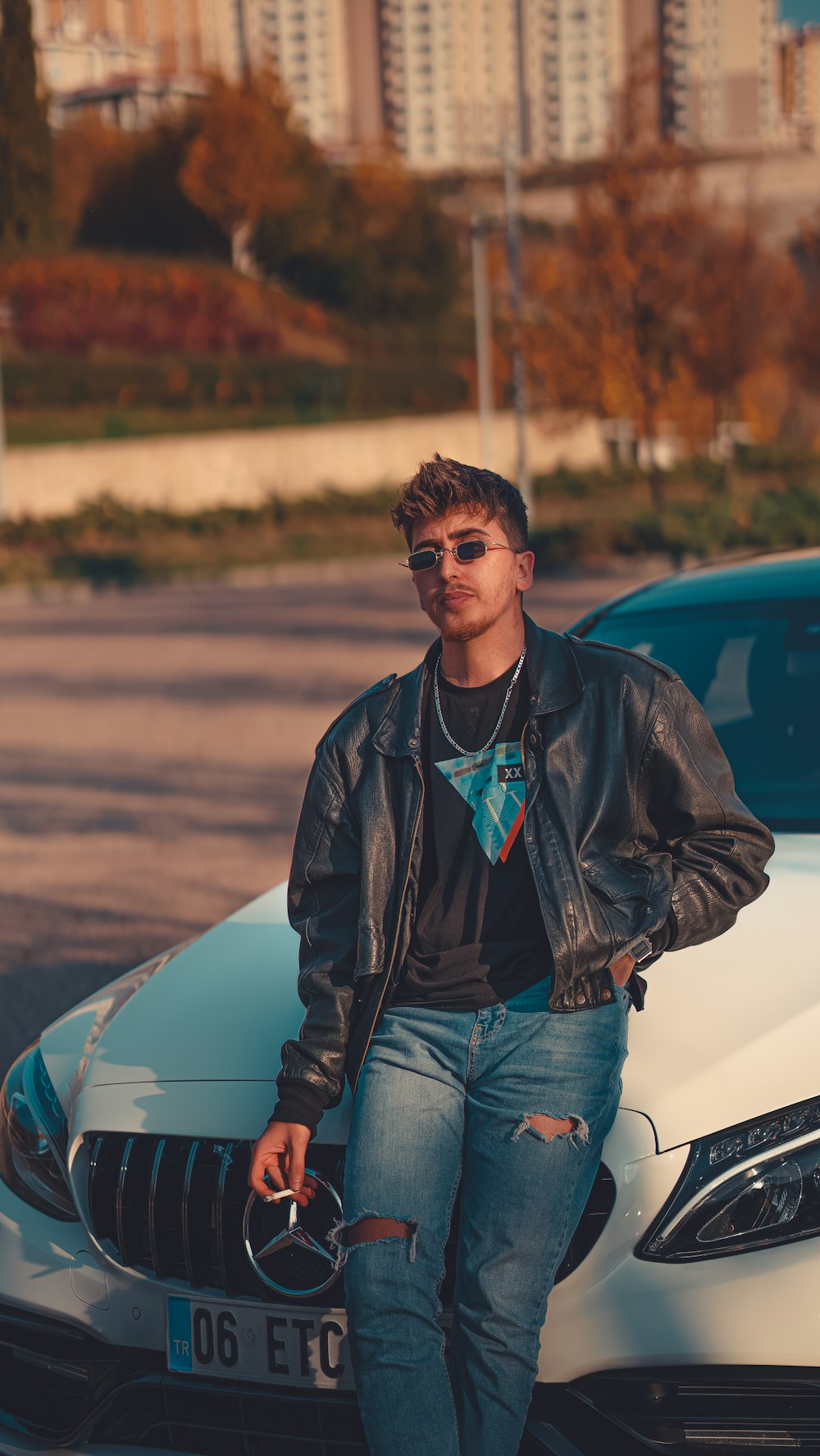 a man standing next to a white car