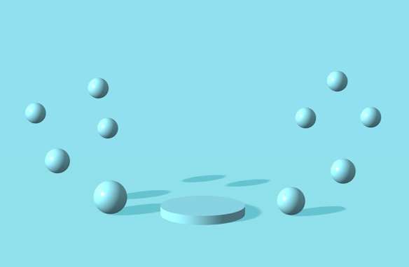A minimalist graphic featuring several light blue spheres arranged in a circular pattern around a central, slightly elevated platform, all against a solid light blue background.