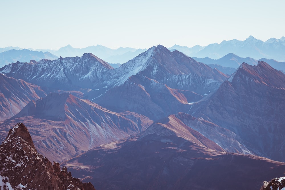 a mountain range with snow covered mountains in the background