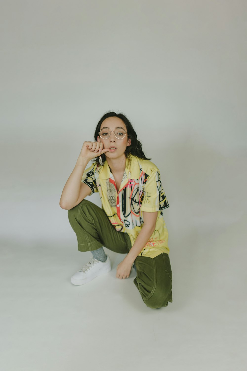 a woman sitting on the ground posing for a picture