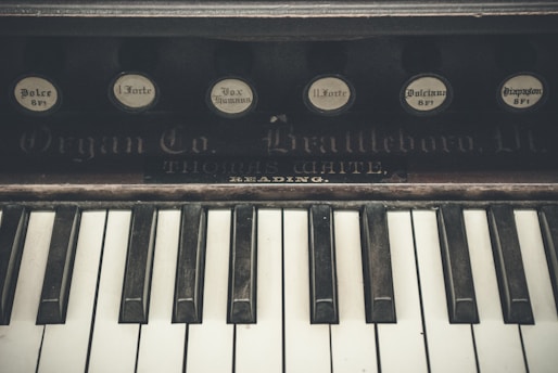 Close-up of vintage keyboard instruments including a Rhodes piano and Hammond organ