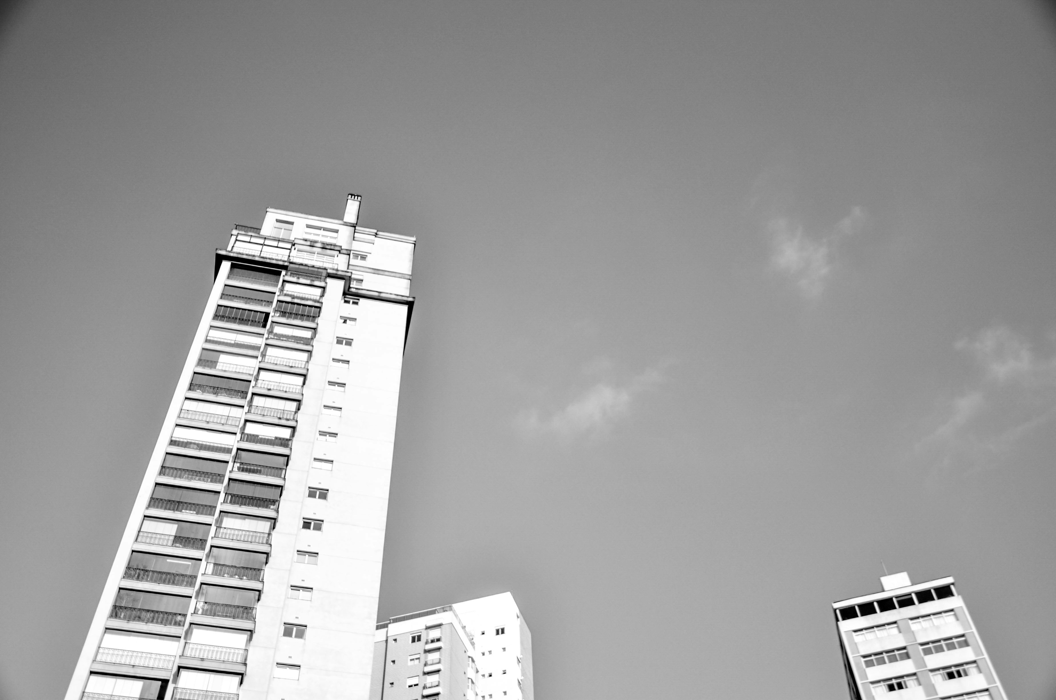 a black and white photo of two tall buildings