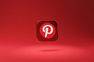 A three-dimensional red icon with a white letter 'P' at its center, floating above a red background. The icon represents the Pinterest logo, which is highlighted by a shadow beneath it, giving it a hovering appearance.