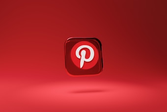 A three-dimensional red icon with a white letter 'P' at its center, floating above a red background. The icon represents the Pinterest logo, which is highlighted by a shadow beneath it, giving it a hovering appearance.