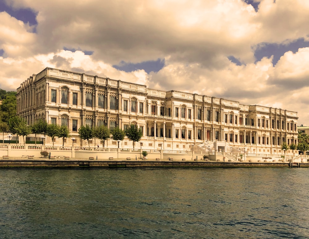 a large building sitting next to a body of water