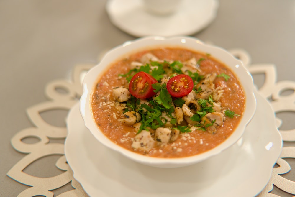 a bowl of soup on a plate on a table