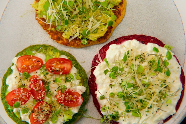 Three small pizzas with toppings on a plate