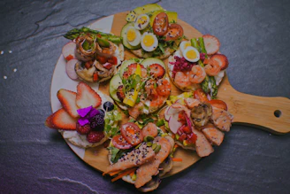 a plate of food that includes shrimp, eggs, and vegetables