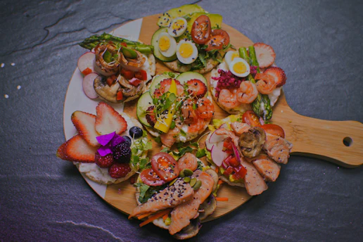 a plate of food that includes shrimp, eggs, and vegetables