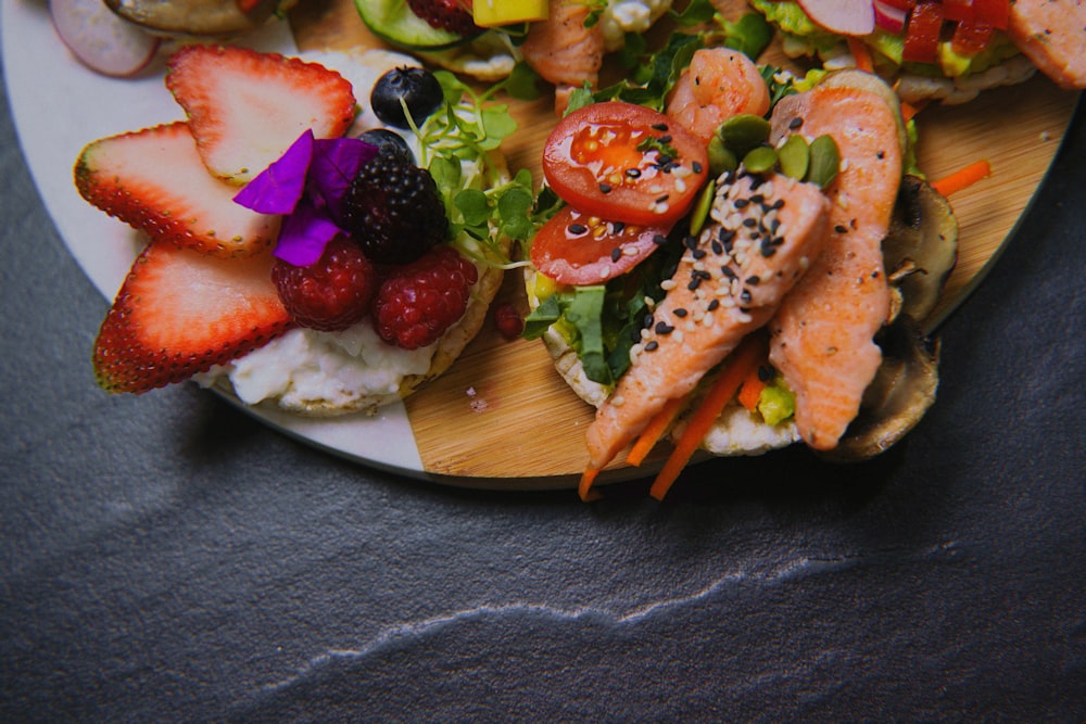 a white plate topped with a salad covered in fruit