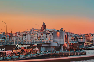 A vibrant sunset over a famous international landmark bustling with travelers