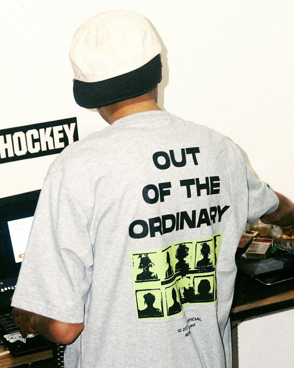a man wearing a t - shirt that says out of the ordinary