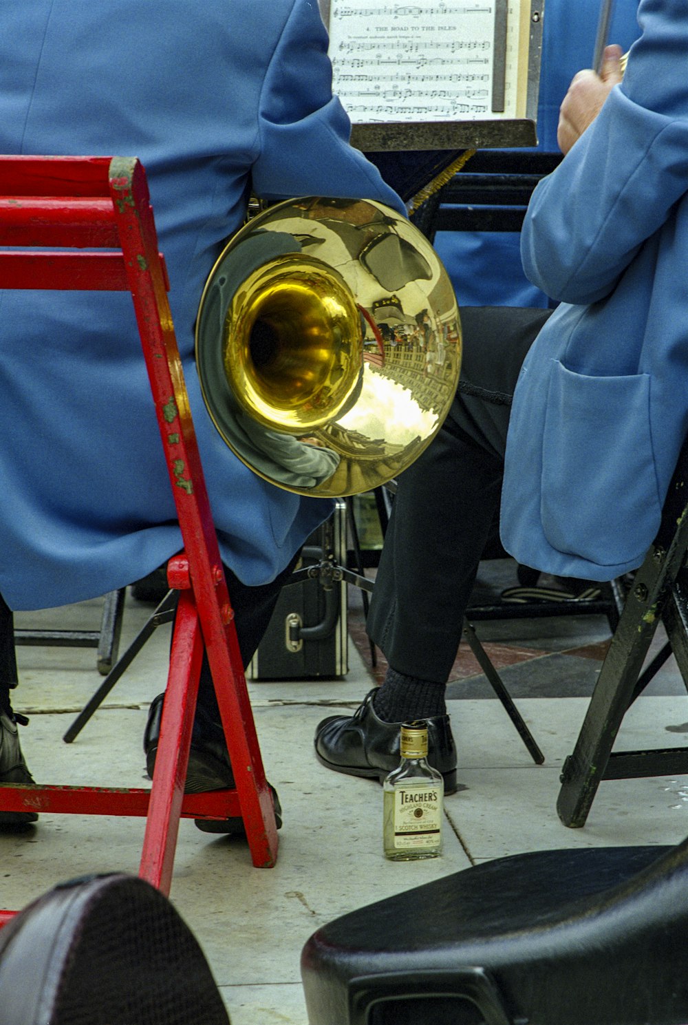 a person sitting in a chair with a trombone