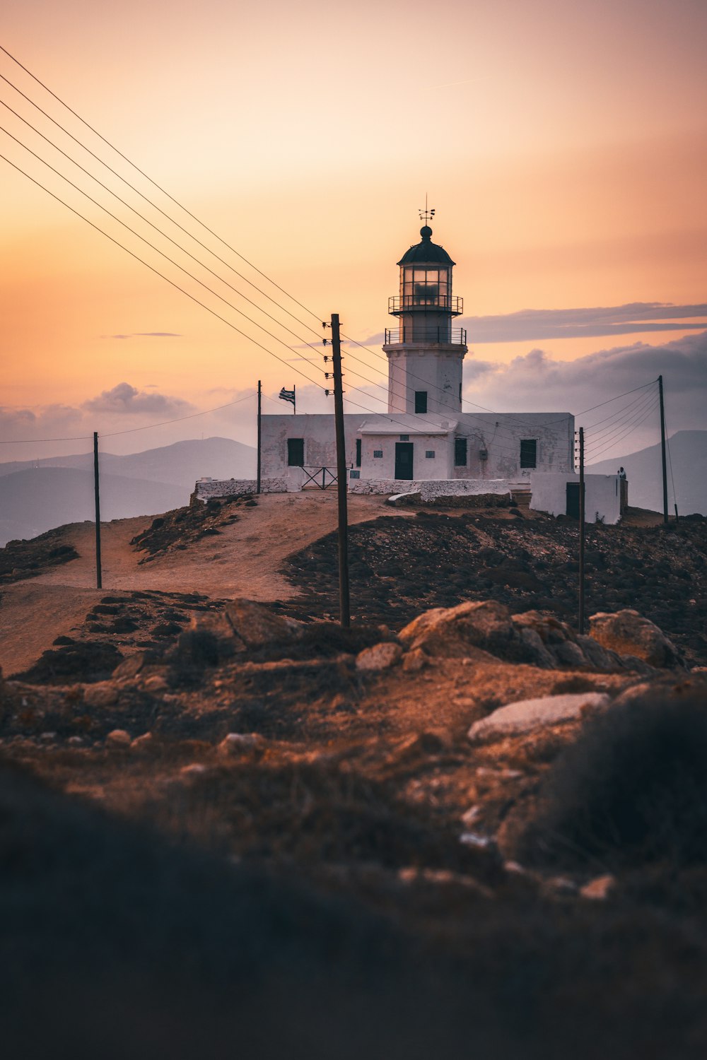 a light house sitting on top of a hill