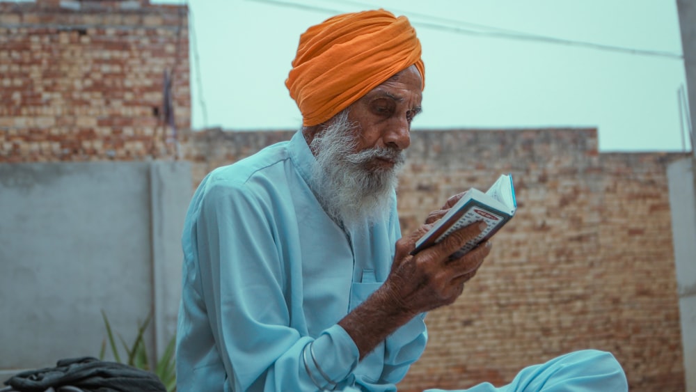 a man in a turban reading a book