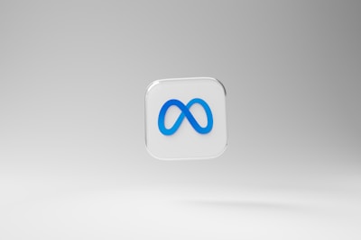 A three-dimensional square icon with a transparent background features a prominent blue infinity symbol in the center. The backdrop is a smooth gradient of light gray tones.
