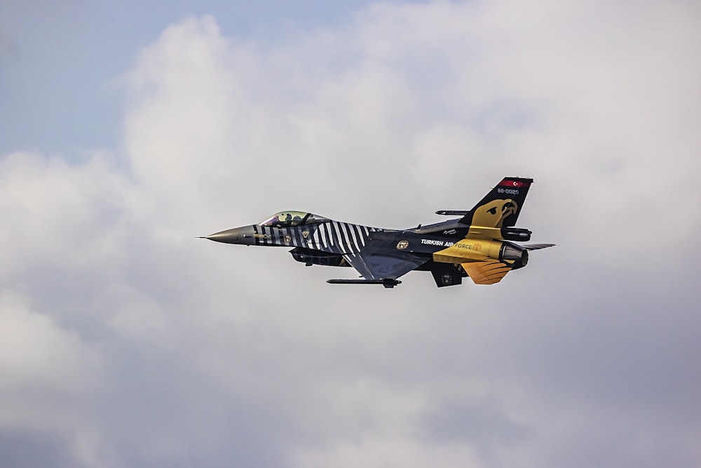 a fighter jet flying through a cloudy sky