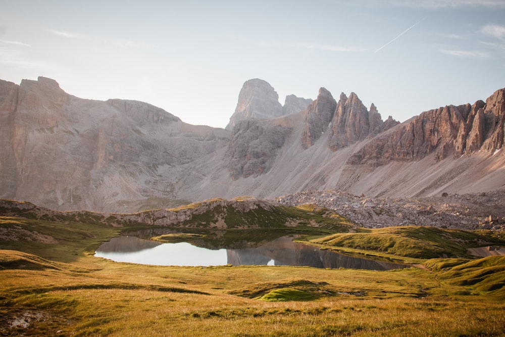 a mountain range with a lake in the foreground