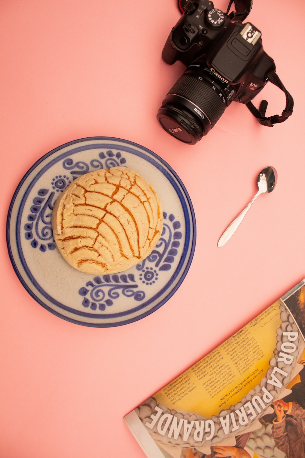 a plate with a cookie on it next to a camera