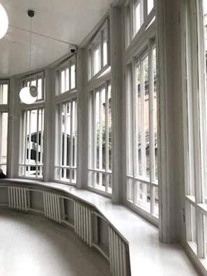 Close-up of a freshly installed modern window with sleek white frames in a cozy living room.