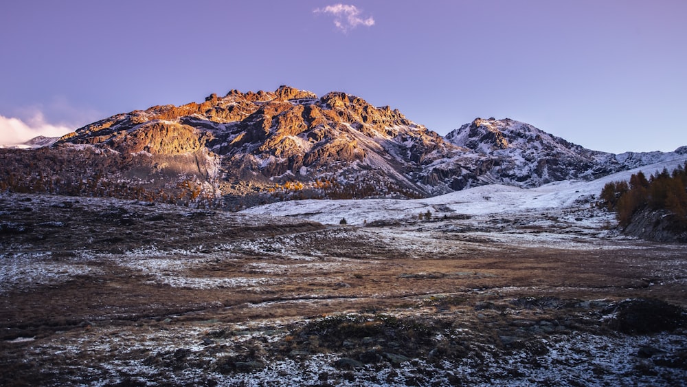 a man standing on top of a snow covered mountain