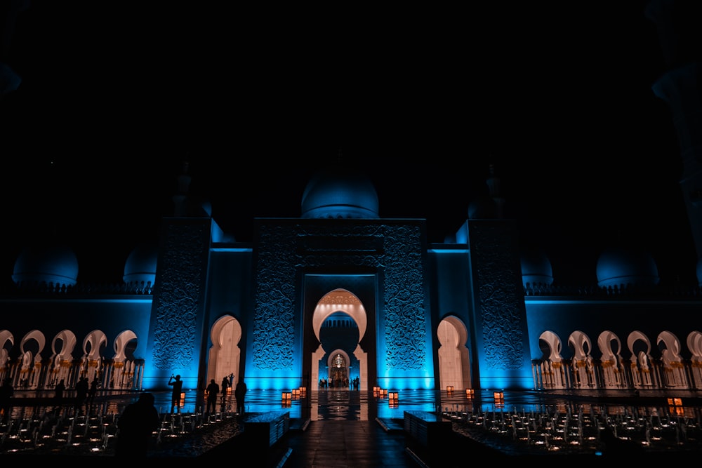 a building lit up with blue lights at night