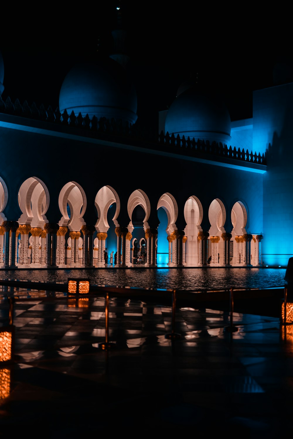 a row of white lanterns lit up in the dark