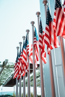 a row of american flags in front of a building
