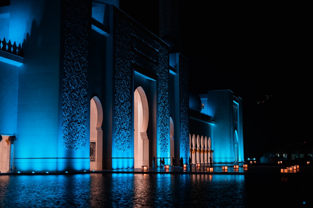 a large building lit up with blue lights