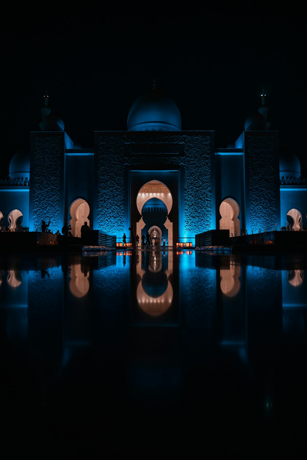 a building lit up with blue lights at night