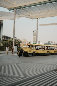 a yellow bus is parked under a canopy