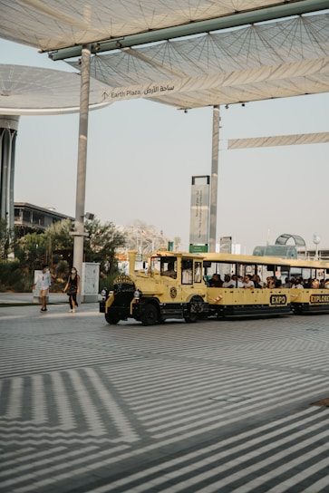 a yellow bus is parked under a canopy