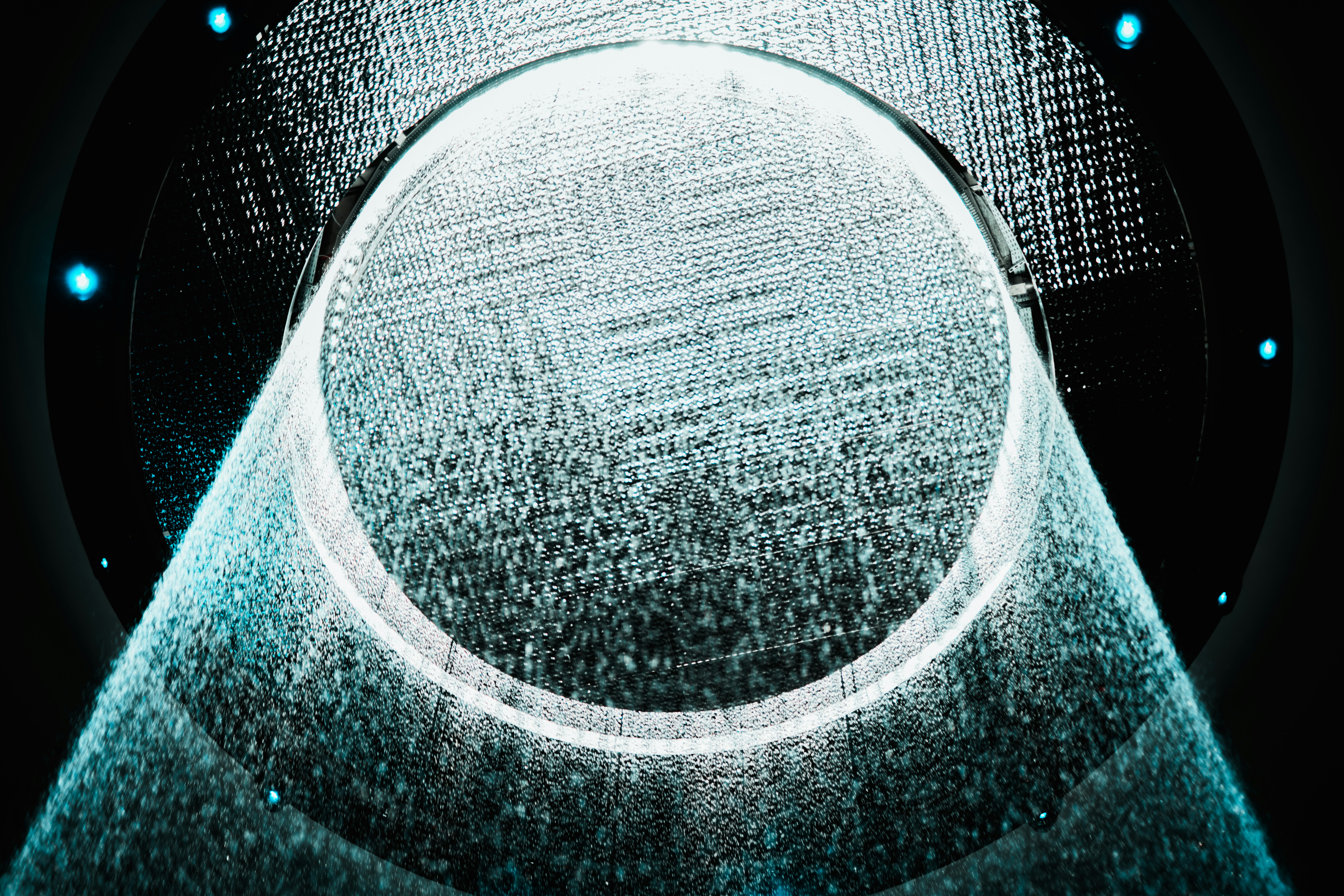 a circular object is shown in the middle of a dark background