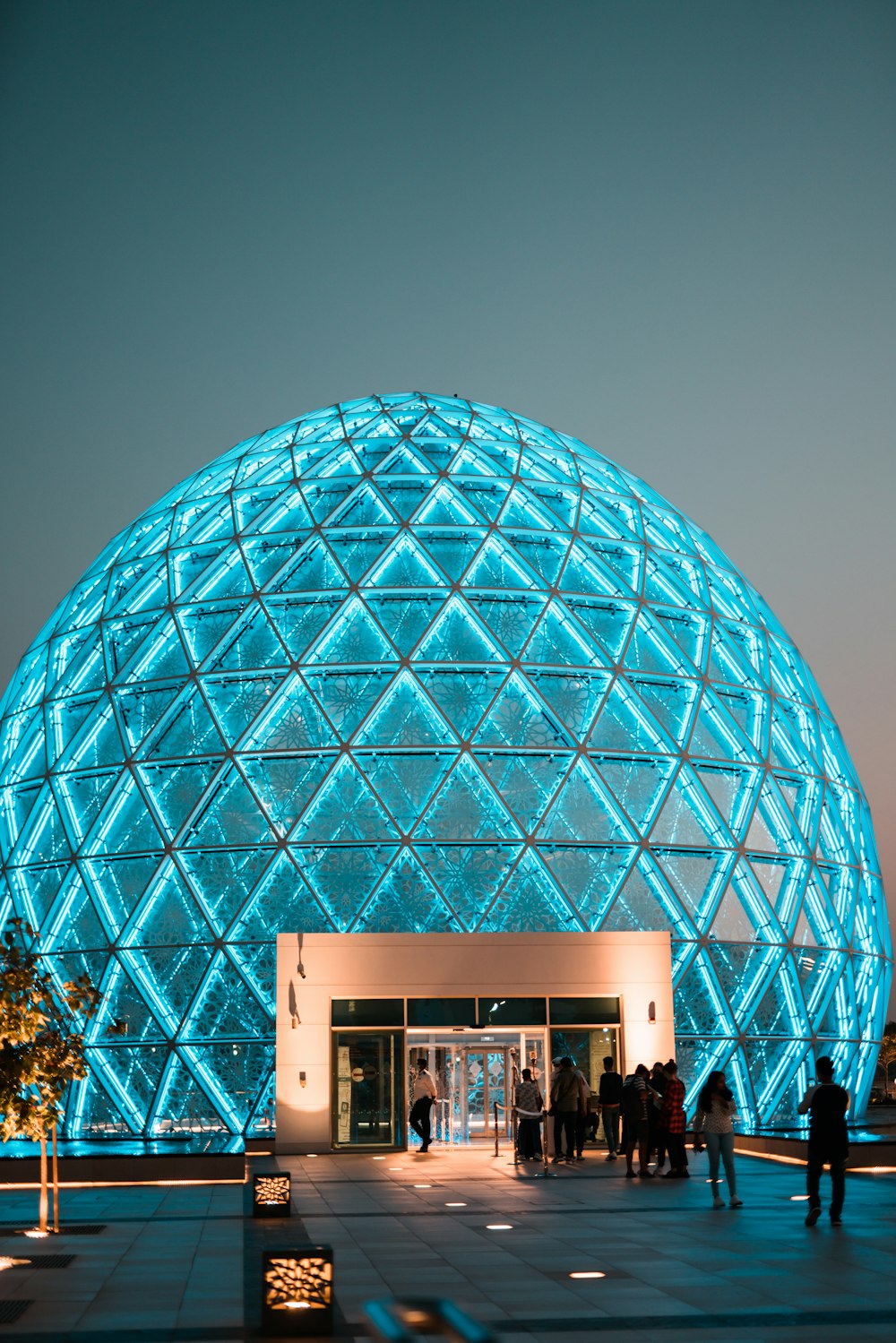 a large building with a giant blue ball on top of it
