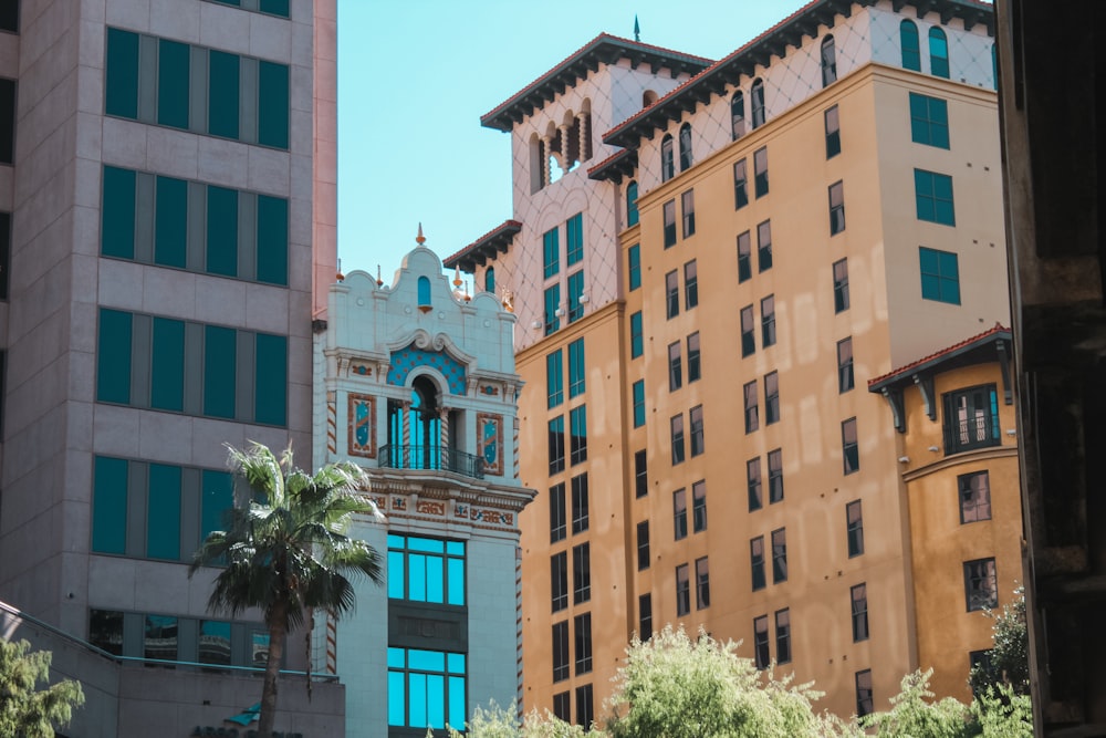 a group of tall buildings with a clock on each of them