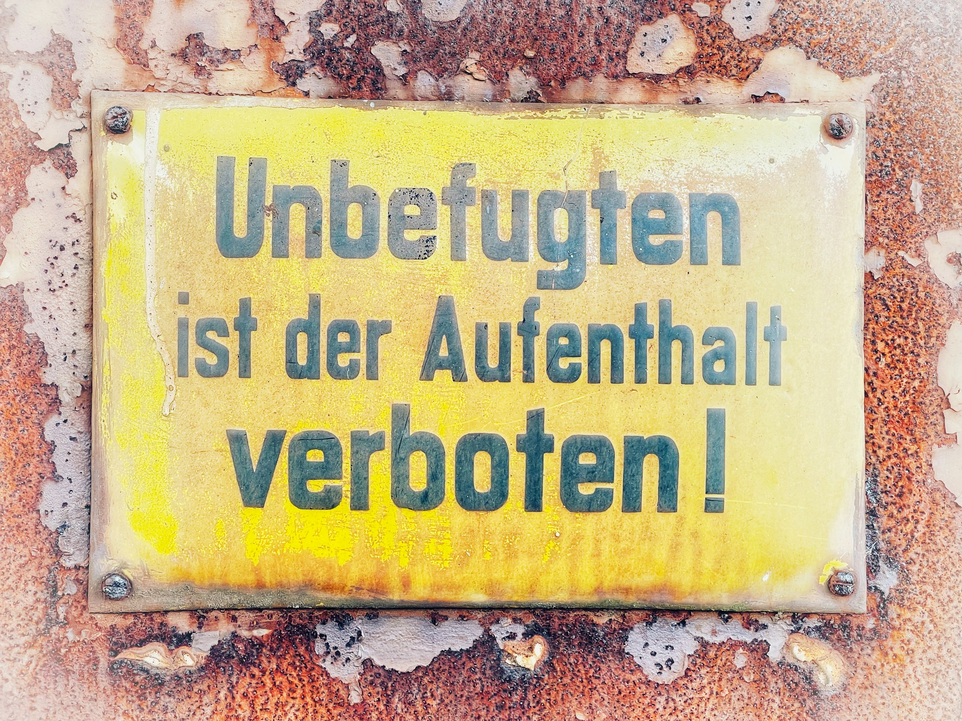 a yellow sign that is on the side of a building