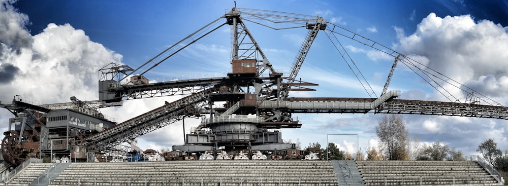 a large crane sitting on top of a cement stadium