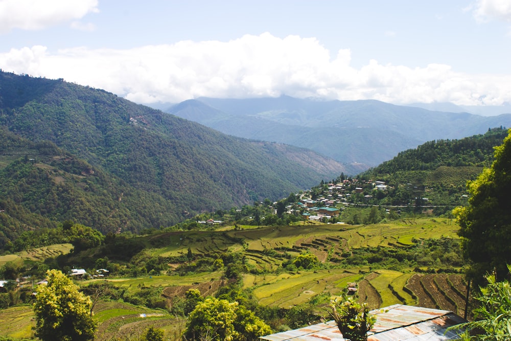 a lush green valley surrounded by mountains