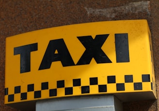 a close up of a taxi sign on a building