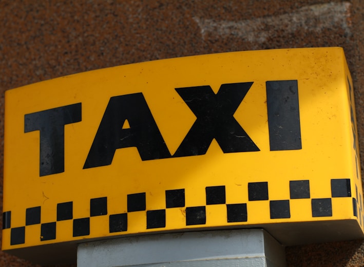 a close up of a taxi sign on a building