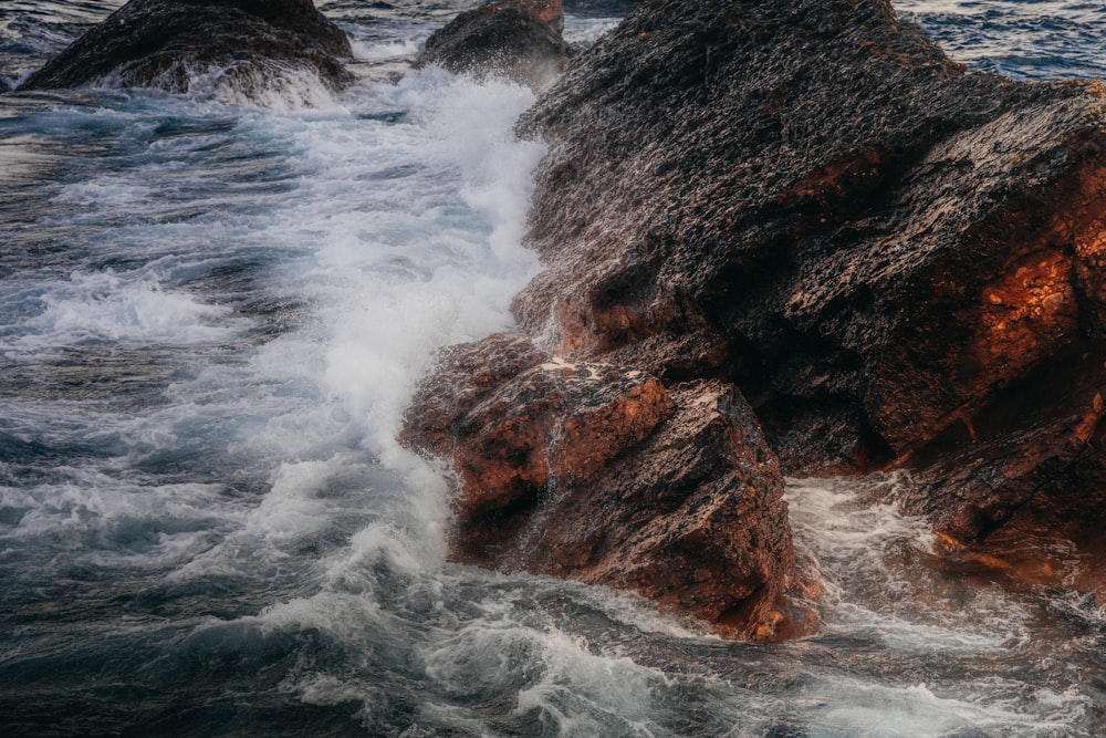 a rocky shore with waves crashing against the rocks