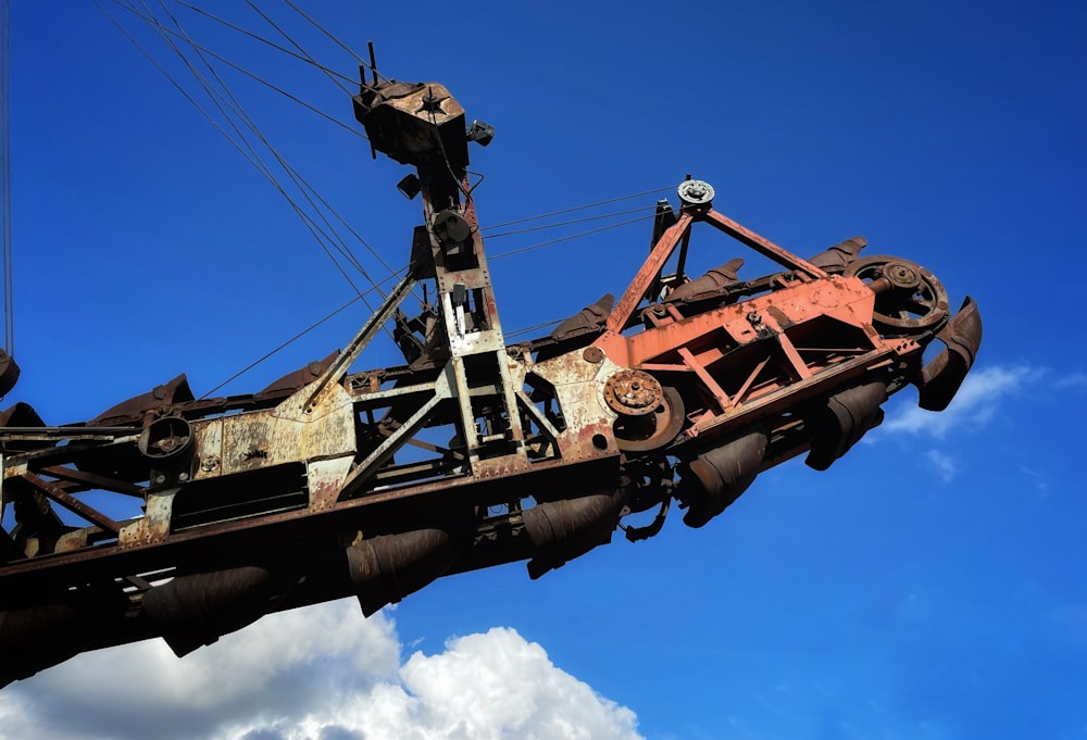 an old rusty crane with a sky background