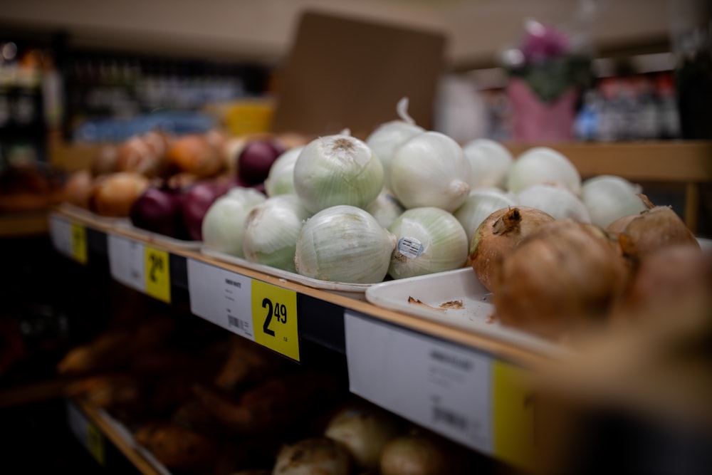 onions and onions are on display in a grocery store