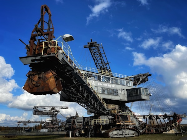 a large crane sitting in the middle of a field