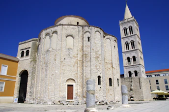 a large white building with a clock tower